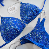 Blue bikini set with rhinestone details on a white background